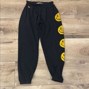 Black aviator nation sweatpants with yellow smiley faces
